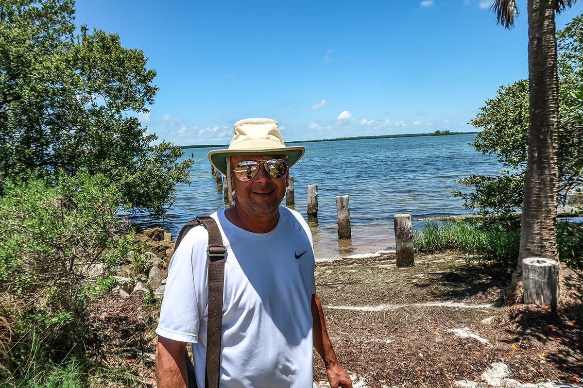 man in the park with ocean in back grown