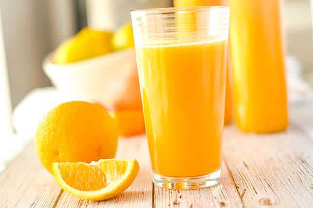 juicing an orange with a juicer