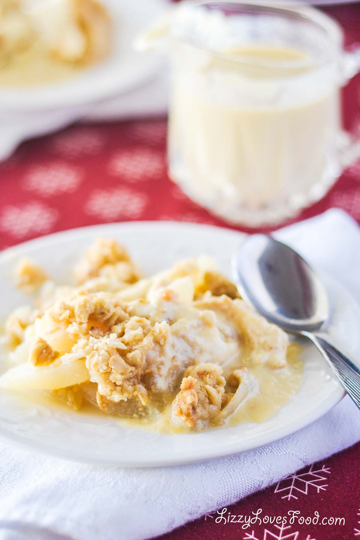 pear crumble on a plate with custard sauce
