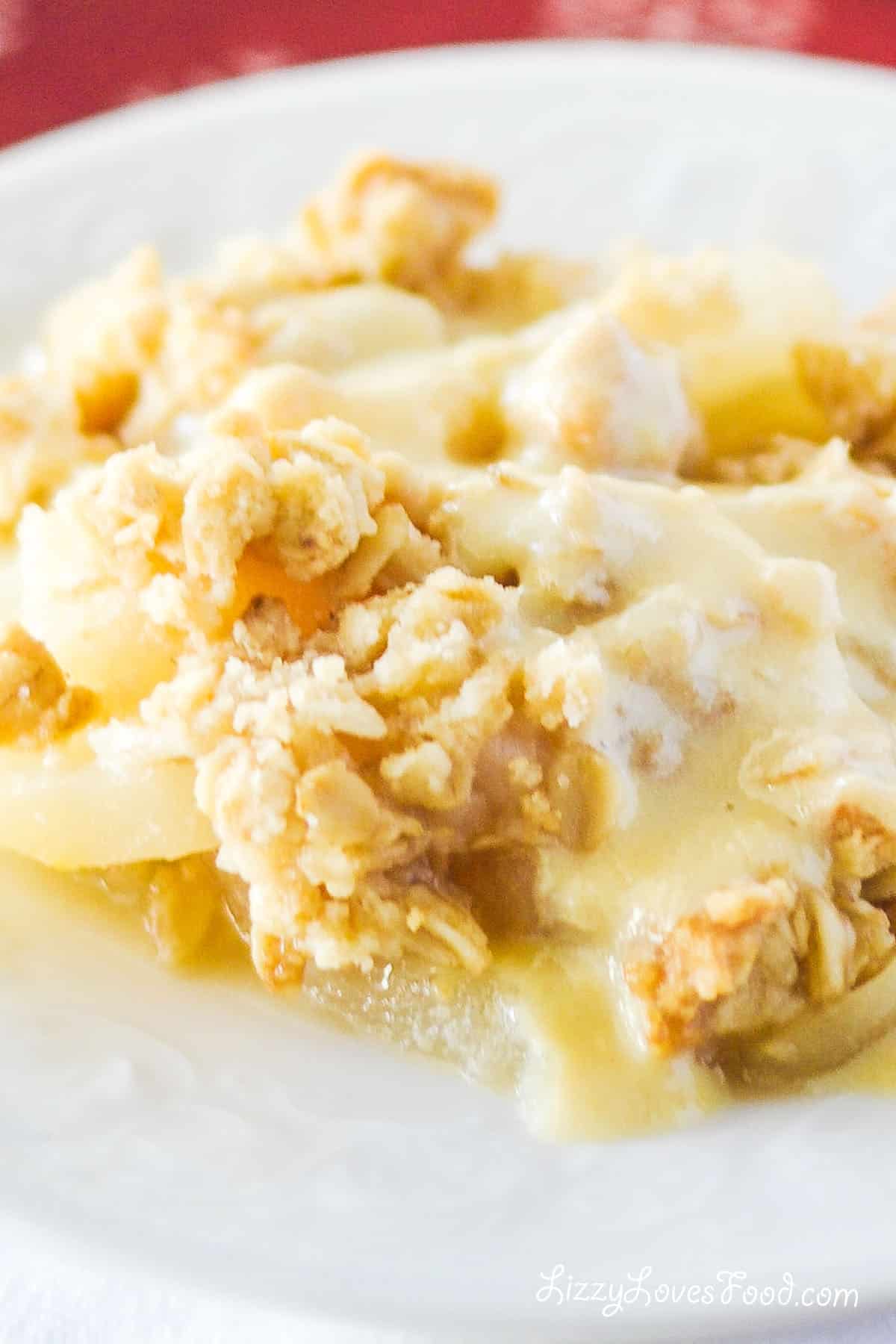 pear crumble on a plate with custard sauce