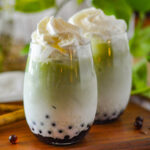 Matcha Bubble Tea on the table with whip cream on top